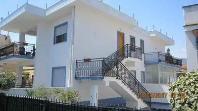 a white building with stairs and balconies on it at La sterlizia in Mondello