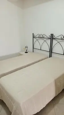 two beds sitting next to each other in a room at Appartamento Nino in San Vito lo Capo