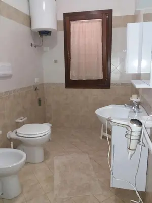 a bathroom with a toilet and a sink at Appartamento Nino in San Vito lo Capo