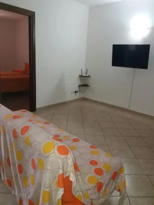 a room with a bed with a polka dot blanket at Appartamento Nino in San Vito lo Capo