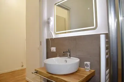 a bathroom with a white sink and a mirror at 315 Via Roma Rooms centro in Palermo