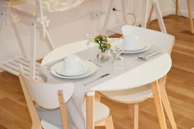 a white table with white dishes and flowers on it at 315 Via Roma Rooms centro in Palermo
