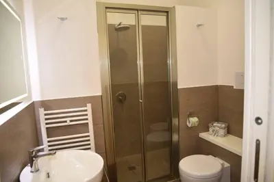 a bathroom with a shower and a toilet and a sink at 315 Via Roma Rooms centro in Palermo
