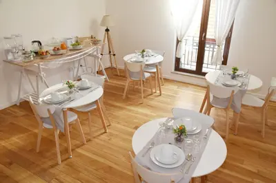 a dining room with white tables and white chairs at 315 Via Roma Rooms centro in Palermo