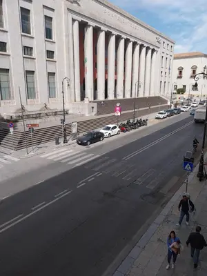 an empty street in front of a large building at 315 Via Roma Rooms centro in Palermo