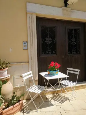 two chairs and a table with a pot of flowers on it at Summer Dream LA CASA SUL MARE in Trappeto