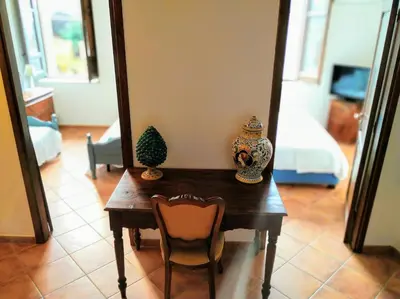 a table with a vase on it in a living room at Summer Dream LA CASA SUL MARE in Trappeto