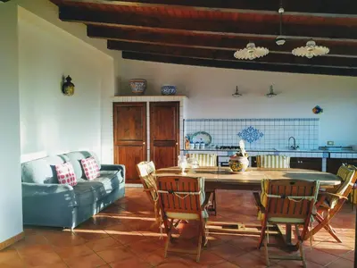 a living room with a couch and a table and chairs at Summer Dream LA CASA SUL MARE in Trappeto