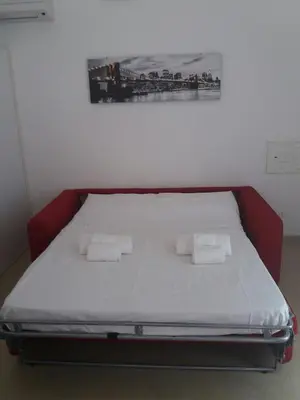 a bed in a room with two towels on it at Maui apartament in Alcamo