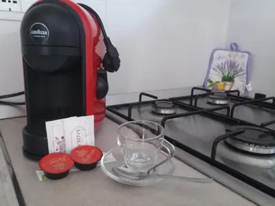 a coffee maker on a counter next to a stove at Maui apartament in Alcamo