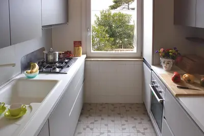 a kitchen with a sink and a stove and a window at Villa Casa Madre in San Vito lo Capo