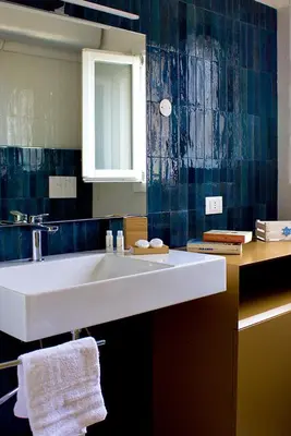 a bathroom with a white sink and a mirror at Villa Casa Madre in San Vito lo Capo