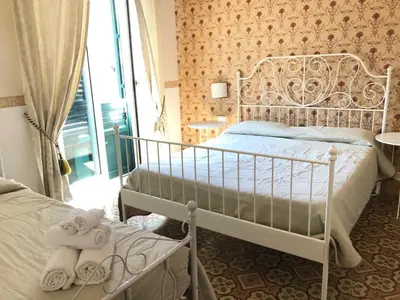 a bedroom with two beds and towels in a room at B&B Dimora Annulina in Palermo