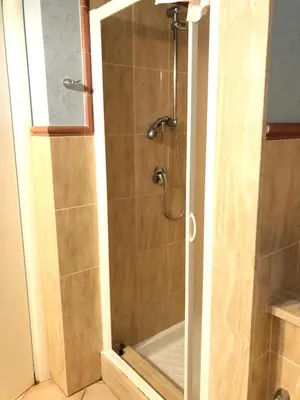 a shower with a glass door in a bathroom at B&B Dimora Annulina in Palermo