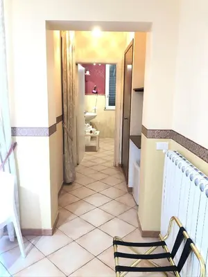 a hallway leading to a bathroom with a tiled floor at B&B Dimora Annulina in Palermo