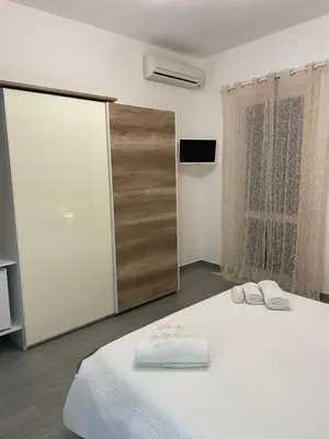 a bedroom with a bed with two towels on it at La Rosa Blu in San Vito lo Capo