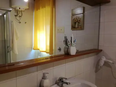 a bathroom with a sink and a mirror at Sunset Flat in Isola delle Femmine