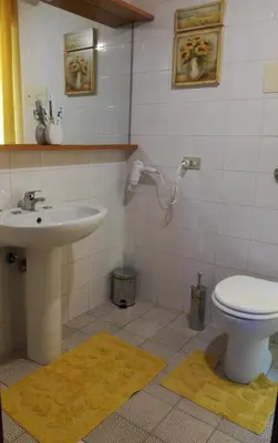 a bathroom with a toilet and a sink at Sunset Flat in Isola delle Femmine
