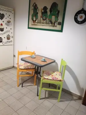 a table and two chairs in a room with a table and two at Sunset Flat in Isola delle Femmine