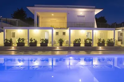 a villa with a swimming pool at night at Villa Del Mare in Alcamo Marina