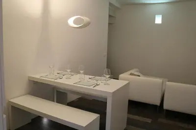 a white table with wine glasses on top of it at Azzurra Tresor in Scopello