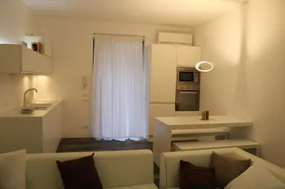 a small living room with a couch and a kitchen at Azzurra Tresor in Scopello