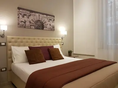 a bedroom with a large bed with two pillows at Casantò guest home in Palermo
