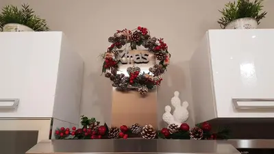 a christmas wreath on a wall with a clock at Casantò guest home in Palermo