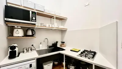 a kitchen with a sink and a microwave at COLORI di PALERMO in Palermo
