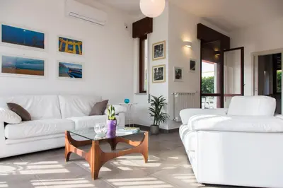 a living room with two white couches and a coffee table at Mondello Martini in Mondello