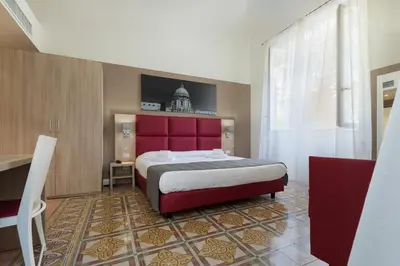 a bedroom with a large bed and a red headboard at Belmonte102 Esclusive Suites in Palermo