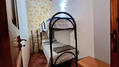 a small room with two bunk beds in it at Dependence Desiree in Alcamo