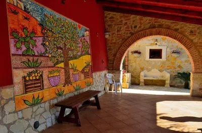 a room with a bench and a painting on the wall at Dependence Desiree in Alcamo