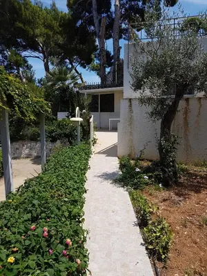 a walkway in front of a house with flowers at Suite Panoramic in Porticello