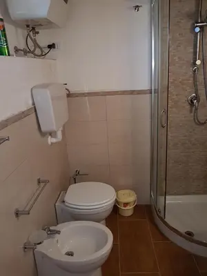a bathroom with a toilet and a shower and a sink at Suite Panoramic in Porticello