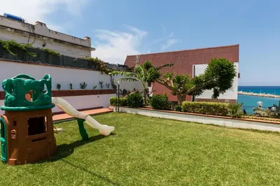a playground on the side of a building with grass at Vero Sicily - Villa San Giorgio in Cinisi