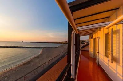 a view of the beach from a balcony of a house at Vero Sicily - Villa San Giorgio in Cinisi