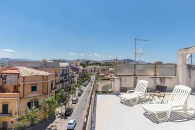 a group of chairs sitting on the roof of a building at Maison Brigitte - Solemar Sicilia in Santa Flavia