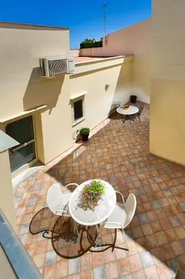 a patio with a table and chairs on a brick floor at 4Canti Case Vacanze in Castellammare del Golfo