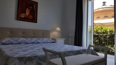 a bedroom with a bed and a window at Porta Maqueda in Palermo