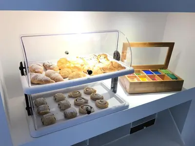 a display case filled with lots of donuts on a shelf at Porta Maqueda in Palermo