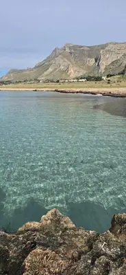 a large body of water with mountains in the background at Al Civico 365 in Castelluzzo