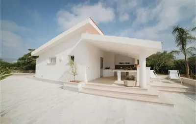 a white house with a large concrete patio at Villa Delle Sterlizie in Valguarnera