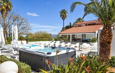 a swimming pool with chairs and a palm tree at Villa Delle Sterlizie in Valguarnera