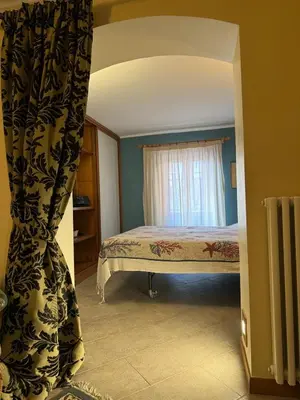a bedroom with a bed and a window at Voile Rouge in Palermo