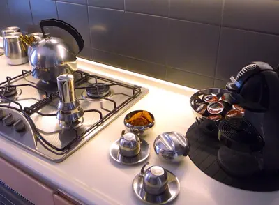 a stove top with a tea pot and pans on it at Gebel Grin in Palermo