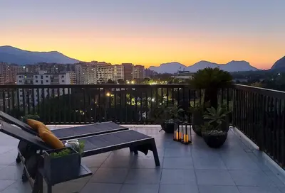 a balcony with a bench and a view of a city at Gebel Grin in Palermo
