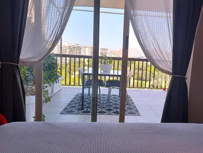 a bedroom with a view of a balcony with a table at Gebel Grin in Palermo