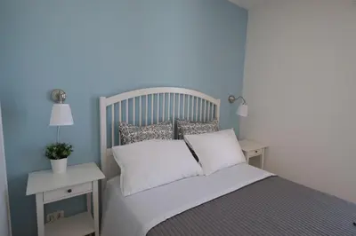 a bed with white sheets and pillows in a bedroom at Blu Marea in Macari