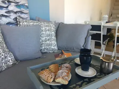 a coffee table with pastries on top of a couch at Blu Marea in Macari